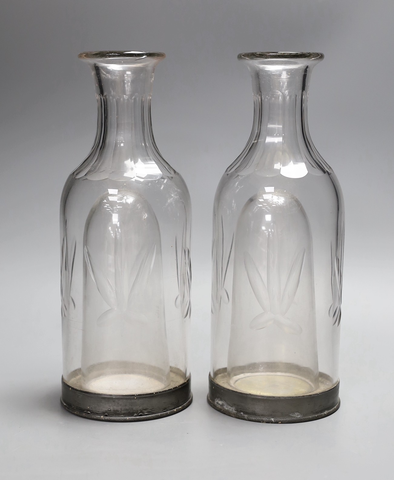 A pair of French glass carafes with silver plated bases and integral ice compartment 28cm